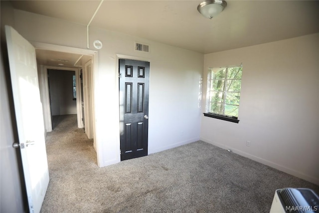 unfurnished room featuring carpet