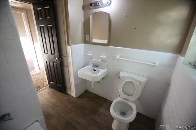 bathroom with toilet, wood-type flooring, and sink