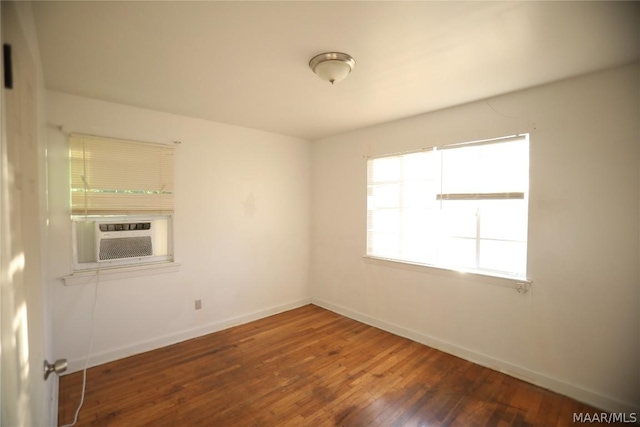 unfurnished room featuring dark wood-type flooring and cooling unit