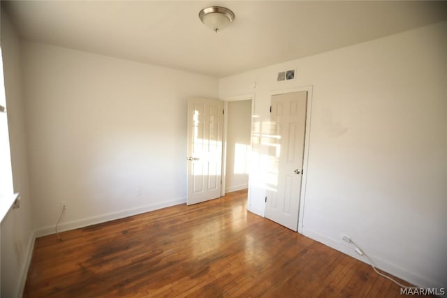 spare room with dark hardwood / wood-style floors