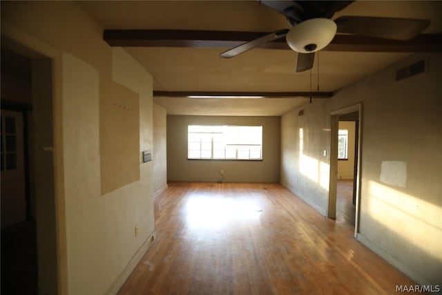 spare room with beam ceiling, ceiling fan, and light hardwood / wood-style flooring