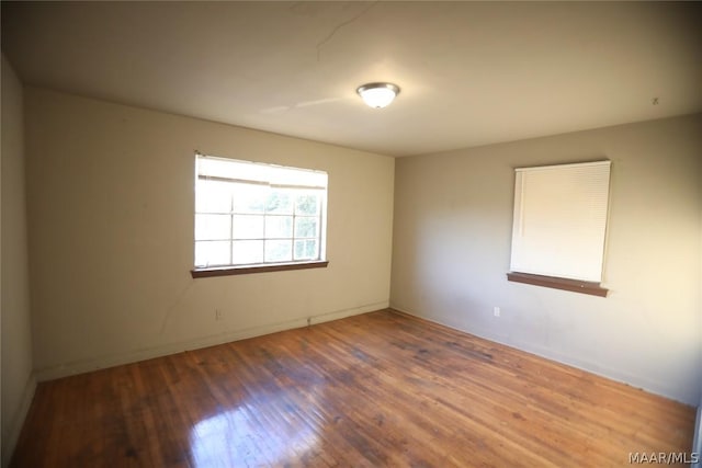 spare room with dark hardwood / wood-style floors