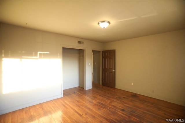 unfurnished bedroom featuring a closet and wood-type flooring