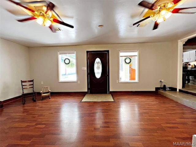 foyer with ceiling fan and dark wood-type flooring