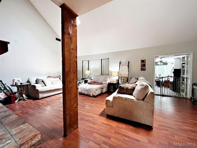 living room featuring ceiling fan, high vaulted ceiling, and hardwood / wood-style flooring