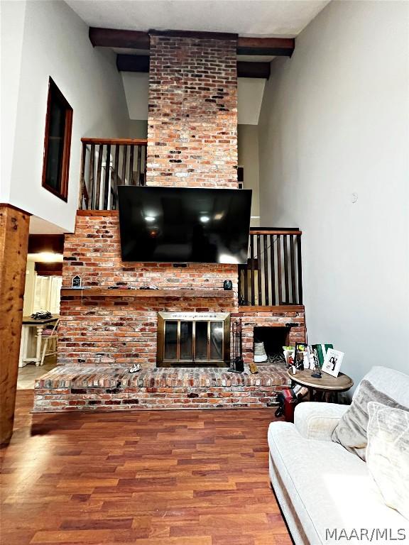 living room featuring a fireplace and hardwood / wood-style flooring