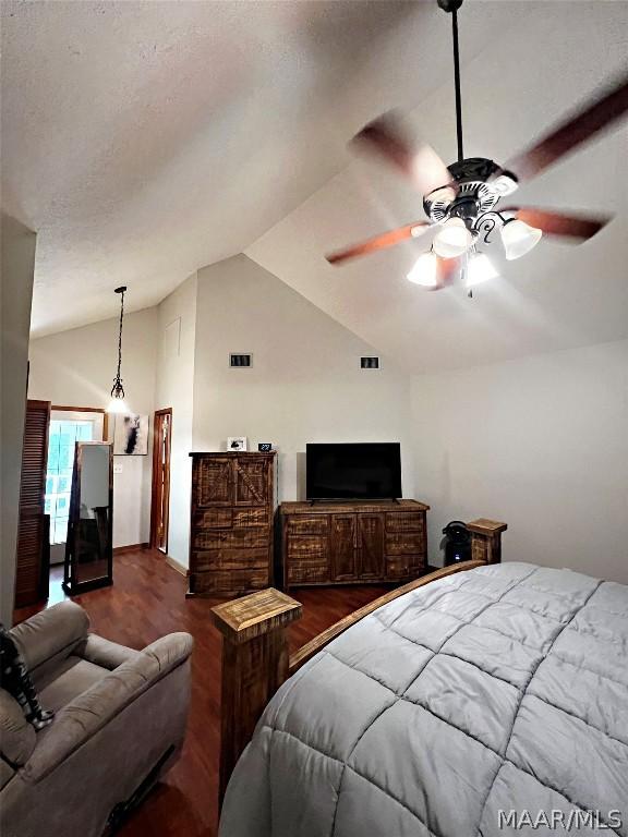 bedroom featuring ceiling fan, dark wood-type flooring, and high vaulted ceiling