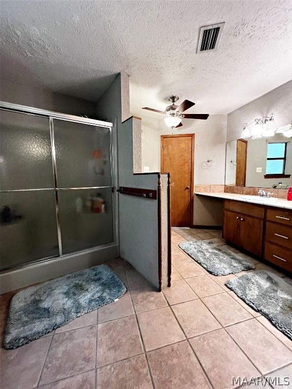 bathroom featuring vanity, a textured ceiling, tile patterned floors, and ceiling fan