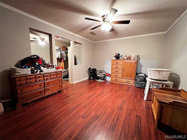 misc room featuring crown molding, dark hardwood / wood-style flooring, and a textured ceiling