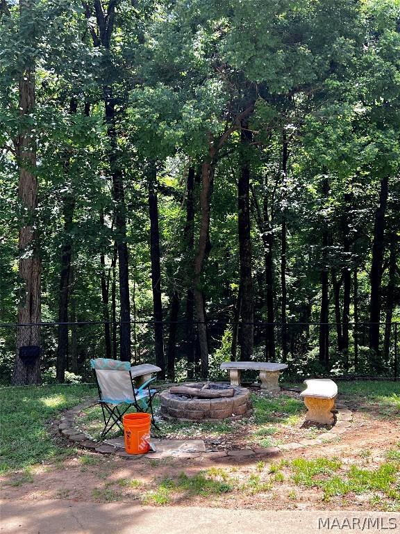 view of yard with a fire pit