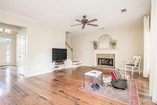 living room with crown molding, ceiling fan, and hardwood / wood-style flooring