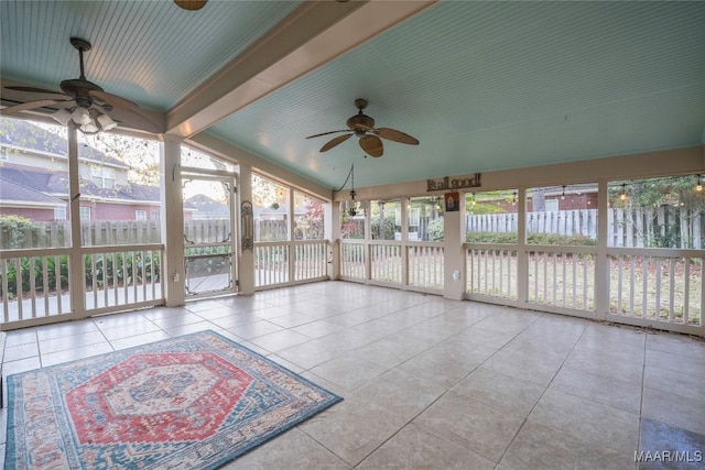 unfurnished sunroom featuring lofted ceiling with beams and ceiling fan