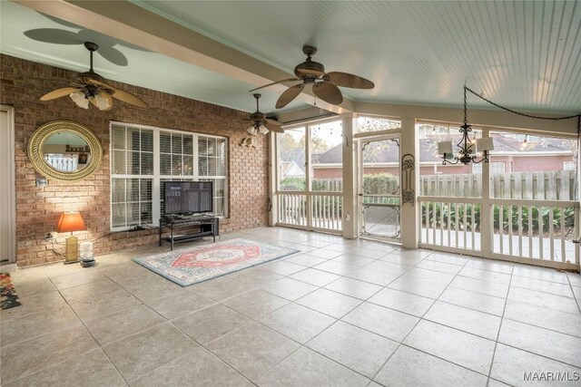 unfurnished sunroom featuring vaulted ceiling and ceiling fan with notable chandelier