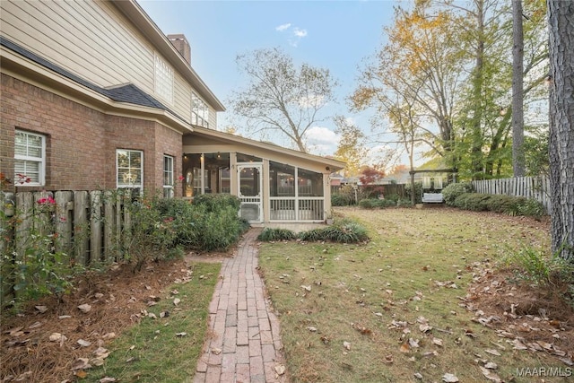 view of yard featuring a sunroom