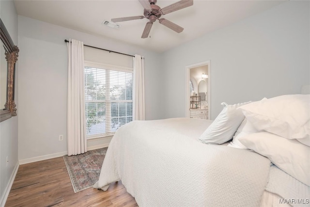 bedroom featuring ceiling fan, ensuite bathroom, and wood-type flooring