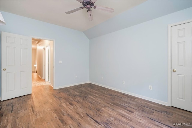 unfurnished bedroom with ceiling fan, wood-type flooring, and vaulted ceiling