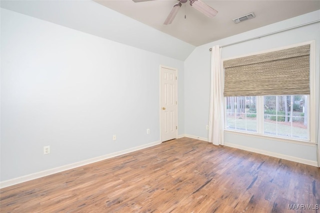 unfurnished room with hardwood / wood-style flooring, ceiling fan, and vaulted ceiling