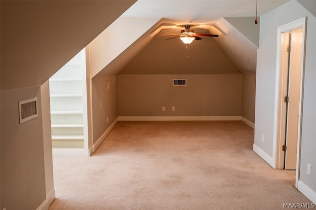 additional living space featuring ceiling fan, lofted ceiling, and light carpet