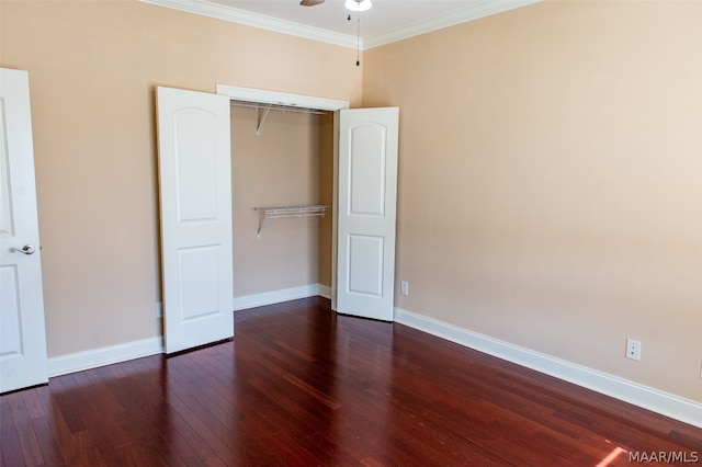 unfurnished bedroom with dark wood-type flooring, a closet, crown molding, and ceiling fan