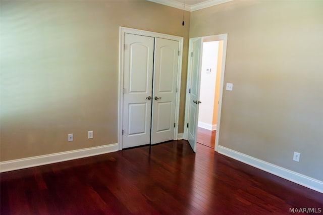 unfurnished bedroom with dark wood-type flooring and ornamental molding