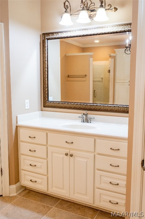 bathroom featuring tile patterned flooring, vanity, and walk in shower