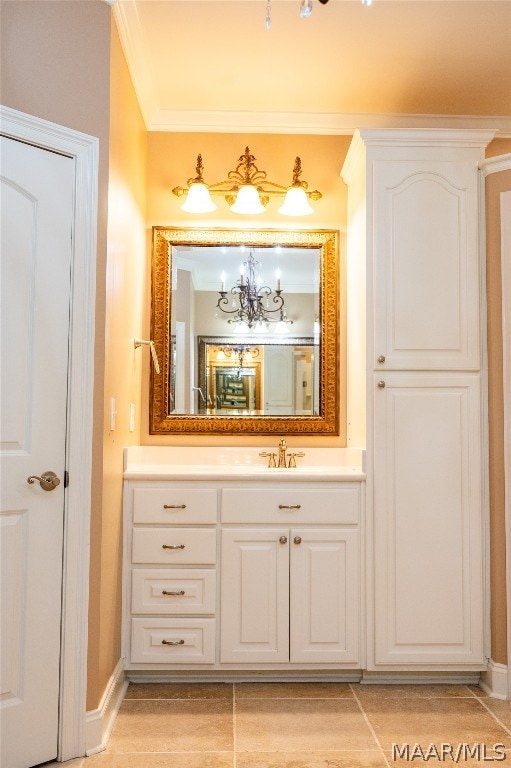 bathroom featuring vanity, crown molding, and a chandelier