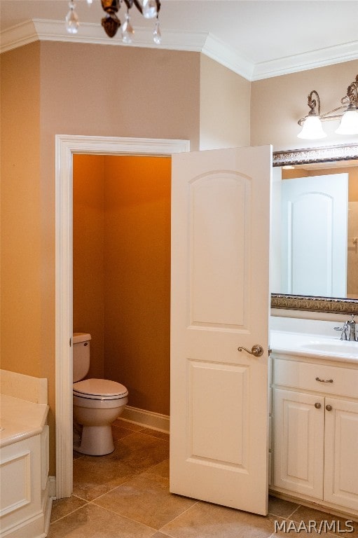 bathroom with tile patterned floors, vanity, toilet, and ornamental molding