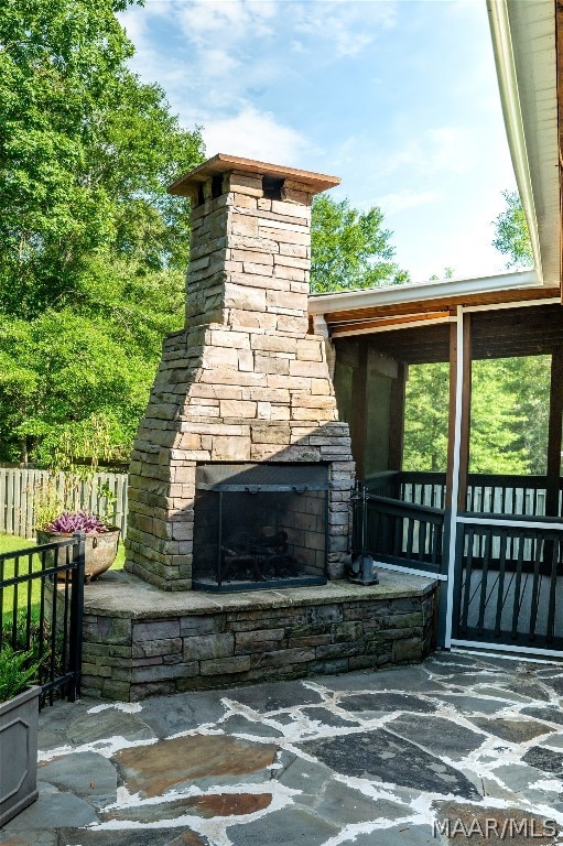 view of patio / terrace featuring an outdoor stone fireplace