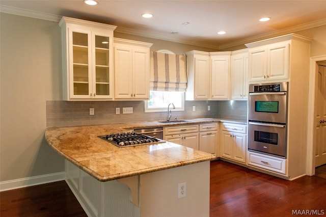 kitchen featuring appliances with stainless steel finishes, white cabinetry, and sink