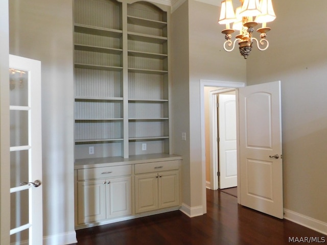 interior space with dark hardwood / wood-style floors and an inviting chandelier