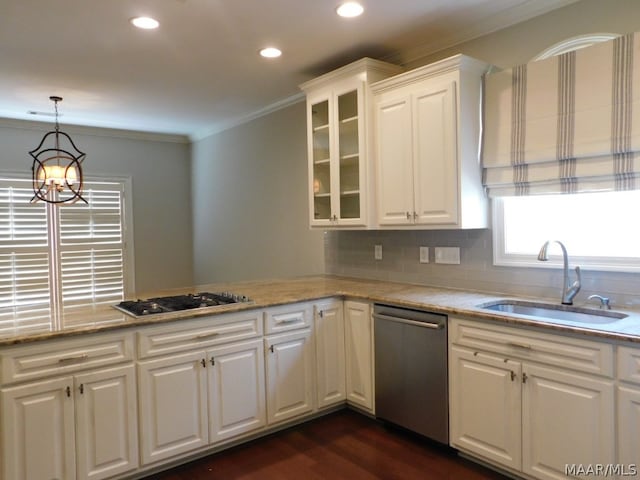 kitchen featuring sink, light stone countertops, a notable chandelier, white cabinetry, and stainless steel appliances