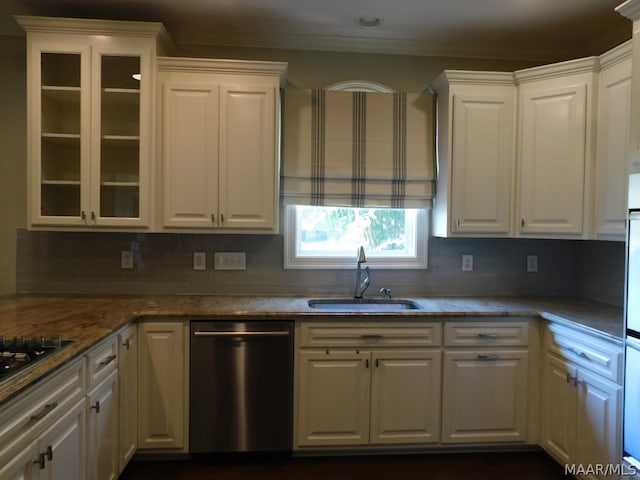 kitchen featuring white cabinets, decorative backsplash, stainless steel dishwasher, and sink