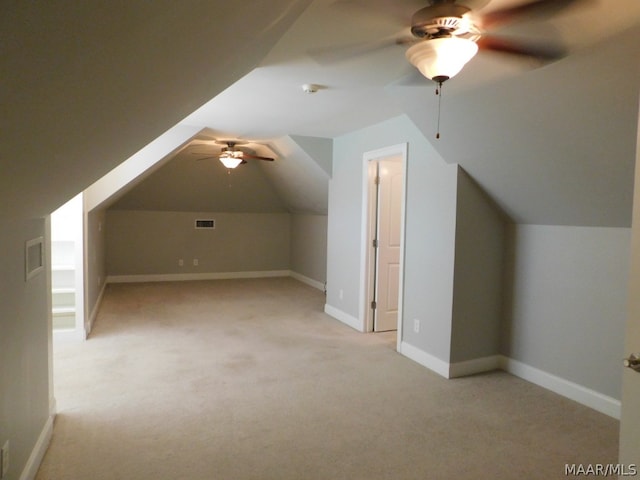 additional living space featuring light colored carpet, vaulted ceiling, and ceiling fan