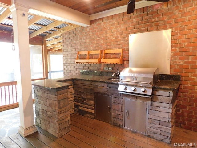 interior space with a grill, sink, and an outdoor kitchen