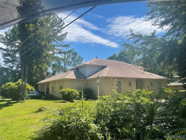 view of home's exterior featuring a yard