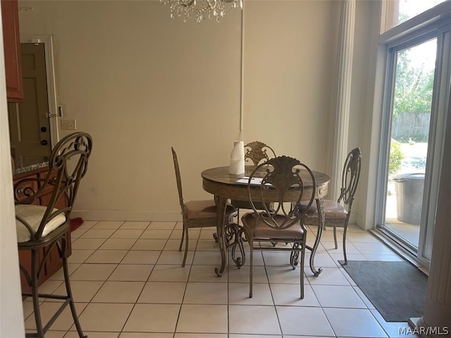 tiled dining space with an inviting chandelier