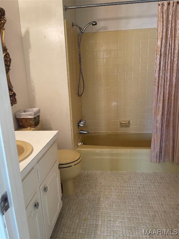 full bathroom featuring shower / bath combination with curtain, vanity, and toilet