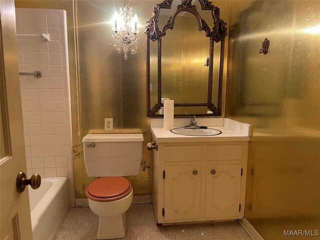 bathroom featuring a washtub, vanity, toilet, and tile patterned flooring