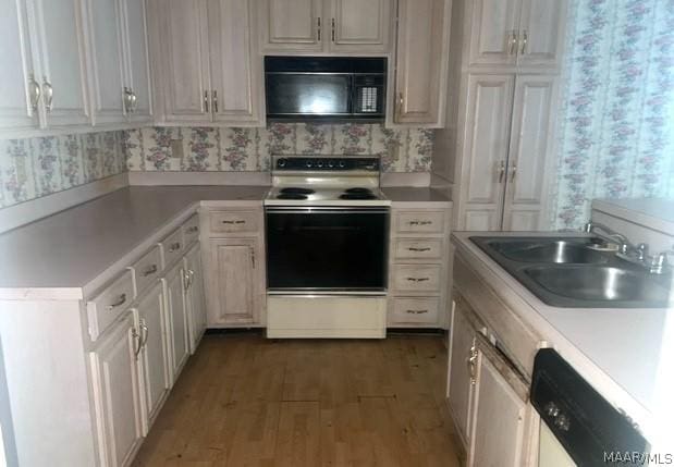 kitchen featuring white cabinetry, dark hardwood / wood-style flooring, white appliances, and sink