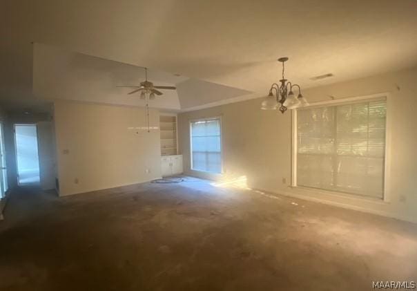 spare room with ceiling fan with notable chandelier