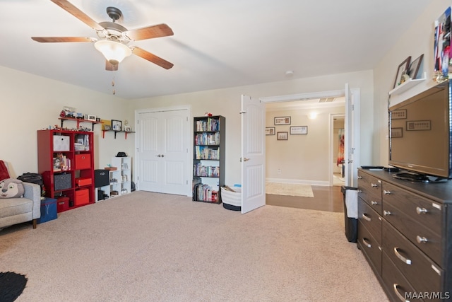 interior space featuring light colored carpet and ceiling fan