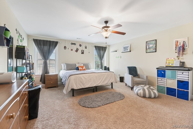 bedroom with carpet flooring, multiple windows, and ceiling fan