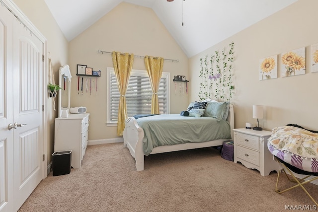 bedroom with a closet, light colored carpet, and lofted ceiling