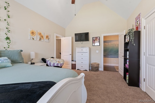 carpeted bedroom with ceiling fan and high vaulted ceiling