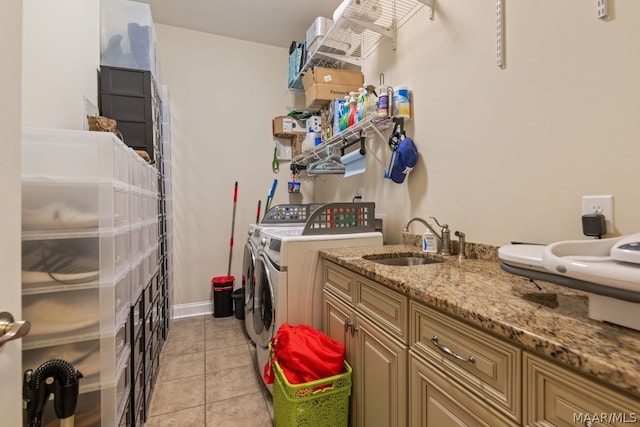 laundry area with sink, light tile patterned floors, cabinets, and independent washer and dryer