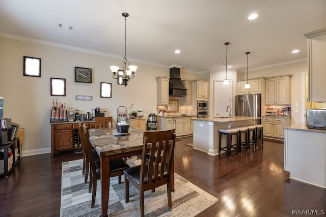 dining area with dark wood-type flooring, sink, ornamental molding, and a notable chandelier