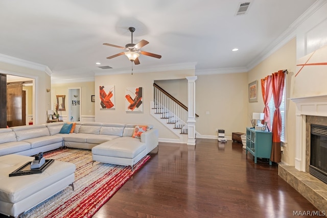 living room with ceiling fan, dark hardwood / wood-style floors, a premium fireplace, and ornamental molding