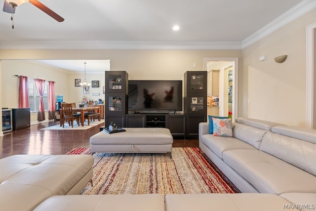 living room featuring crown molding, ceiling fan with notable chandelier, and dark hardwood / wood-style floors