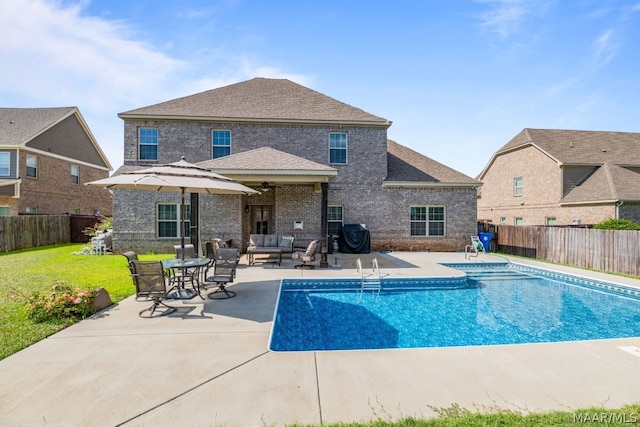 view of swimming pool with a yard, an outdoor hangout area, and a patio area