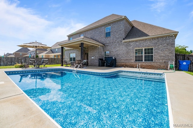 view of swimming pool with a patio and grilling area